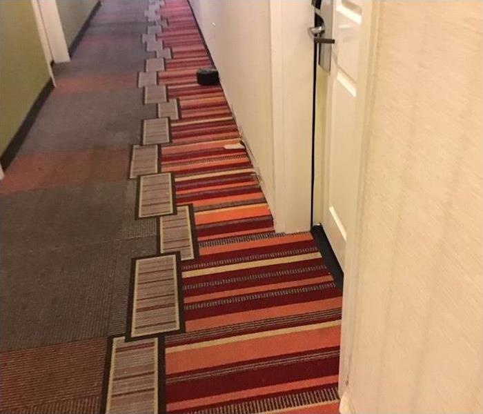 Hotel hallway with brown, orange and yellow carpet