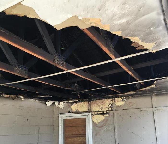 Fire on Porch, Punched hole in ceiling showing exposed burnt trusses
