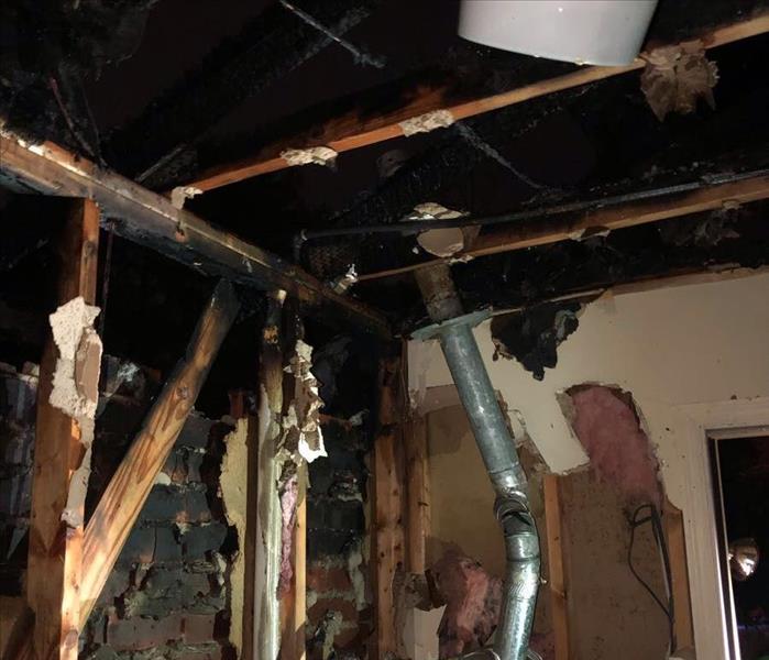 Room with fire damage on walls and ceiling